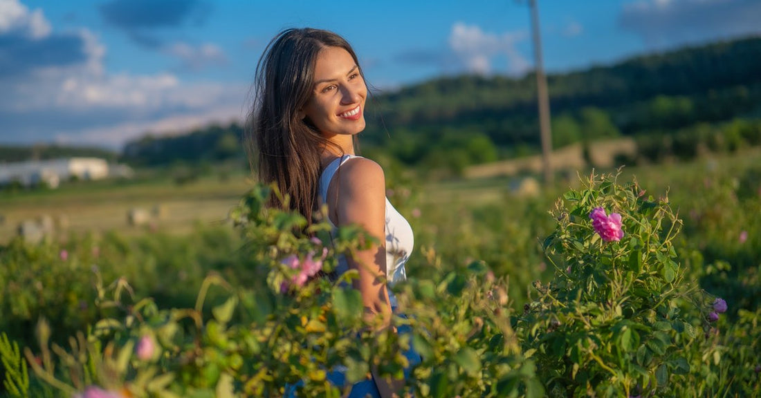 Nő virágzó rózsamezőn a bolgár Rózsák völgyében
